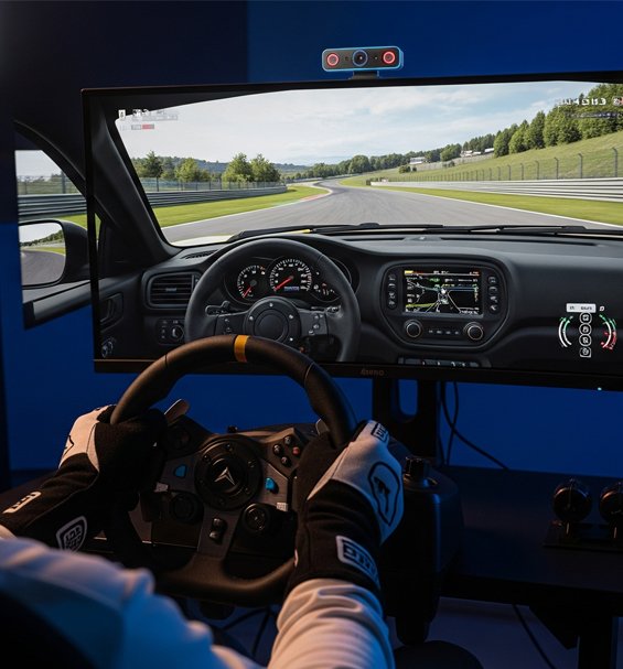A sim racing setup with a steering wheel, pedals, and a monitor showing a race.